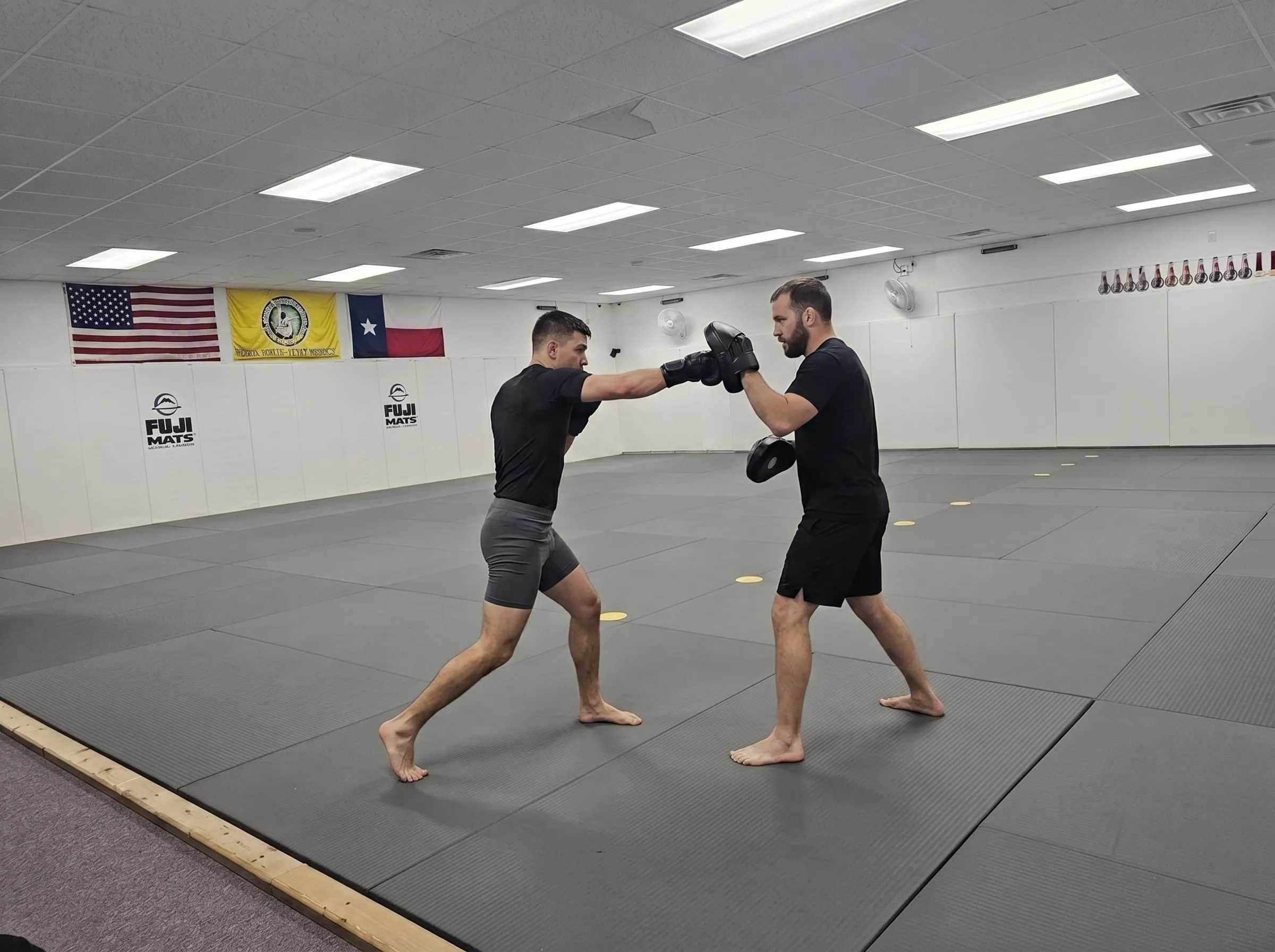Adults working the pads during kickboxing class at Dynamic Martial Arts